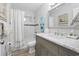 This bathroom features a shower and tub, white tile, and a gray vanity with marble countertop at 1223 Naylor Ave., Myrtle Beach, SC 29577