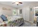 This bedroom offers a bed with floral bedding, wood floors, and bright natural light from a window at 1223 Naylor Ave., Myrtle Beach, SC 29577