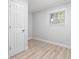 Bright bedroom features a window, neutral paint, and wood look floors at 1223 Naylor Ave., Myrtle Beach, SC 29577