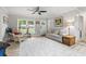 Bright living room featuring hardwood floors, ceiling fan and a large window for natural light at 1223 Naylor Ave., Myrtle Beach, SC 29577