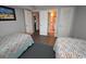 Comfortable bedroom with twin beds and easy access to a well-lit bathroom at 1310 N Waccamaw Dr. # 102, Garden City Beach, SC 29576