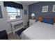 Bright bedroom with a window offering a lovely ocean view, complemented by simple and coastal decor at 1310 N Waccamaw Dr. # 102, Garden City Beach, SC 29576