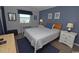 Cozy bedroom with blue walls, ocean view from the window and comfortable furniture at 1310 N Waccamaw Dr. # 102, Garden City Beach, SC 29576