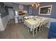 Charming dining area with chandelier lighting open to the adjacent kitchen at 1310 N Waccamaw Dr. # 102, Garden City Beach, SC 29576
