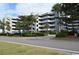 A wide exterior shot showing the condo community and landscaping on a bright day at 1310 N Waccamaw Dr. # 102, Garden City Beach, SC 29576
