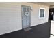 Unit 102 front door is decorated with a door wreath and welcome mat at 1310 N Waccamaw Dr. # 102, Garden City Beach, SC 29576