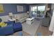 Cozy living room with comfortable seating and sliding glass doors to the balcony at 1310 N Waccamaw Dr. # 102, Garden City Beach, SC 29576