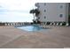 Sparkling pool with surrounding lounge chairs and a beautiful ocean backdrop at 1310 N Waccamaw Dr. # 102, Garden City Beach, SC 29576