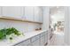 Bright kitchen showcases ample counter space, white cabinets, stainless steel hardware, and seamless access to the dining area at 137 Stride Ct., Myrtle Beach, SC 29588