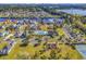 Aerial view featuring lush landscaping, a community pool, and lake views at 1410 Bohicket Ct., Myrtle Beach, SC 29579