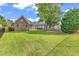 Spacious backyard featuring a lush lawn, mature trees, and a black metal fence at 1410 Bohicket Ct., Myrtle Beach, SC 29579