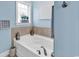 Soaking tub under a window in this bathroom, accented by decor and tiling at 1410 Bohicket Ct., Myrtle Beach, SC 29579