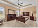 A bright bedroom with carpet, a ceiling fan, and dark wood bedroom furniture at 1410 Bohicket Ct., Myrtle Beach, SC 29579