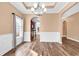 Open dining room with hardwood floors, chandelier, and view into the kitchen at 1410 Bohicket Ct., Myrtle Beach, SC 29579