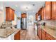 Well-lit kitchen boasts granite countertops, stainless appliances, wood floors, and ample cabinet space at 1410 Bohicket Ct., Myrtle Beach, SC 29579