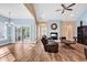Cozy living room with a fireplace, wood flooring, and access to the outdoor patio at 1410 Bohicket Ct., Myrtle Beach, SC 29579