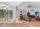 Spacious living room with vaulted ceilings, fireplace, sliding doors to patio, and wood flooring at 1410 Bohicket Ct., Myrtle Beach, SC 29579