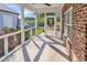 Relaxing screened porch with brick accent and view of the backyard at 1410 Bohicket Ct., Myrtle Beach, SC 29579