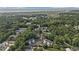 Aerial view of a coastal neighborhood surrounded by lush trees and a glimpse of the ocean at 157 Egret Run Ln. # 523, Pawleys Island, SC 29585