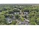 Aerial view showcasing homes and a community pool surrounded by trees and parking areas at 157 Egret Run Ln. # 523, Pawleys Island, SC 29585
