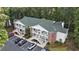 Aerial view of building complex with brick siding, green roof, multiple balconies and parking lot at 157 Egret Run Ln. # 523, Pawleys Island, SC 29585