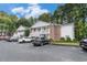 Well-maintained two-story condo building with parking, surrounded by lush trees and landscaping at 157 Egret Run Ln. # 523, Pawleys Island, SC 29585