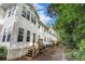 Exterior view of townhouse featuring white siding, multiple windows and wooden back porch stairs at 157 Egret Run Ln. # 523, Pawleys Island, SC 29585
