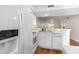 Bright kitchen features white appliances, wood floors, and a clean, modern design at 157 Egret Run Ln. # 523, Pawleys Island, SC 29585