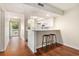 Kitchen with white cabinets, breakfast bar, and dark wood floors with an open concept feel at 157 Egret Run Ln. # 523, Pawleys Island, SC 29585