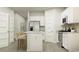 Modern kitchen with white cabinets, stainless steel appliances, and island seating at 1704 Hunting Harris Ct # 1, Ocean Isle Beach, NC 28469