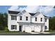 Charming townhome featuring black shutters, covered entryways, and white garage doors at 1708 Hunting Harris Ct # 2, Ocean Isle Beach, NC 28469