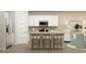 Modern kitchen featuring a kitchen island with a white countertop and wooden stools at 1708 Hunting Harris Ct # 2, Ocean Isle Beach, NC 28469