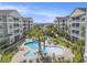 Aerial view of a complex featuring a pool, palm trees, and well-maintained landscaping at 172 Ella Kinley Circle # 101, Myrtle Beach, SC 29588