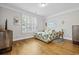 Cozy bedroom with plantation shutters, hardwood floors, and tropical decor at 172 Ella Kinley Circle # 101, Myrtle Beach, SC 29588
