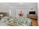 Spacious bedroom showcasing hardwood floors and a decorative leaf-patterned bedspread at 172 Ella Kinley Circle # 101, Myrtle Beach, SC 29588