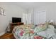 Comfortable bedroom with a floral bedspread, TV, and access to the bathroom at 172 Ella Kinley Circle # 101, Myrtle Beach, SC 29588