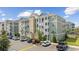 Beautiful condominium building with parking spaces, nice landscaping, and well-maintained exterior at 172 Ella Kinley Circle # 101, Myrtle Beach, SC 29588