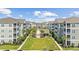 A charming courtyard with manicured lawn, palm trees, and condos creating a serene communal space at 172 Ella Kinley Circle # 101, Myrtle Beach, SC 29588