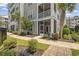 Exterior view of a condo with a patio, lush landscaping, and palm trees at 172 Ella Kinley Circle # 101, Myrtle Beach, SC 29588