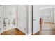 Bright hallway featuring hardwood floors and white doors leading to the bathroom and living room at 172 Ella Kinley Circle # 101, Myrtle Beach, SC 29588