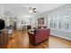 Comfortable living room with hardwood floors, ceiling fan, and open to the kitchen and dining areas at 172 Ella Kinley Circle # 101, Myrtle Beach, SC 29588