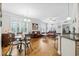 Open-concept living room featuring a dining area, hardwood floors, and plenty of natural light at 172 Ella Kinley Circle # 101, Myrtle Beach, SC 29588