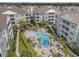 A refreshing community pool surrounded by lounge chairs and tropical landscaping amongst multi-story condos at 172 Ella Kinley Circle # 101, Myrtle Beach, SC 29588