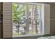 View of a pool and surrounding complex visible through the window with white shutters at 172 Ella Kinley Circle # 101, Myrtle Beach, SC 29588