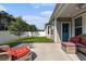 Cozy covered back patio with outdoor seating and a view of the fenced-in backyard with a small patch of grass at 1741 Parish Way, Myrtle Beach, SC 29577