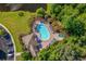 Overhead view of an outdoor swimming pool, lounge area, spa, and clubhouse surrounded by trees at 1833 Lake Egret Dr., North Myrtle Beach, SC 29582