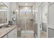 Bathroom showing a tiled shower with glass doors, a sink, and a vanity mirror at 1833 Lake Egret Dr., North Myrtle Beach, SC 29582