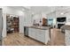 The kitchen showcases an island, pantry, stainless steel appliances, and wood flooring at 1833 Lake Egret Dr., North Myrtle Beach, SC 29582