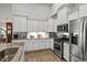 The kitchen offers stainless steel appliances, granite counters, and stylish white cabinetry at 1833 Lake Egret Dr., North Myrtle Beach, SC 29582