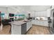 Spacious kitchen boasts white cabinets, granite counters, stainless appliances, and an island with seating at 1833 Lake Egret Dr., North Myrtle Beach, SC 29582
